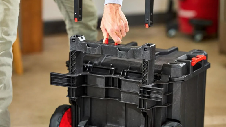 Person removing the handle from a Bauer modular rolling toolbox