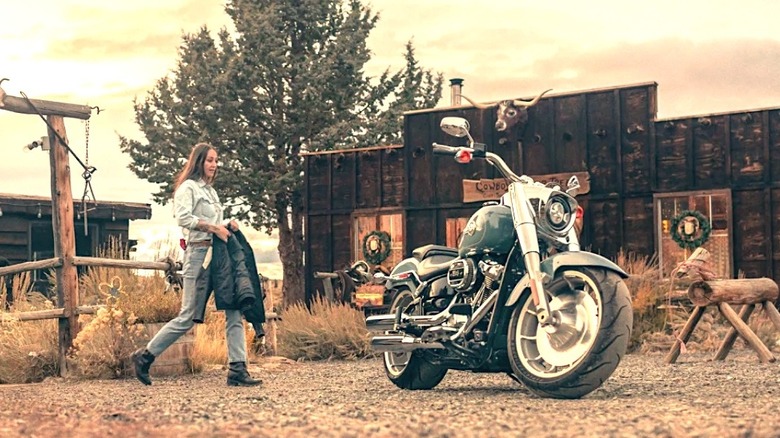 Woman approaching Harley Fat Boy