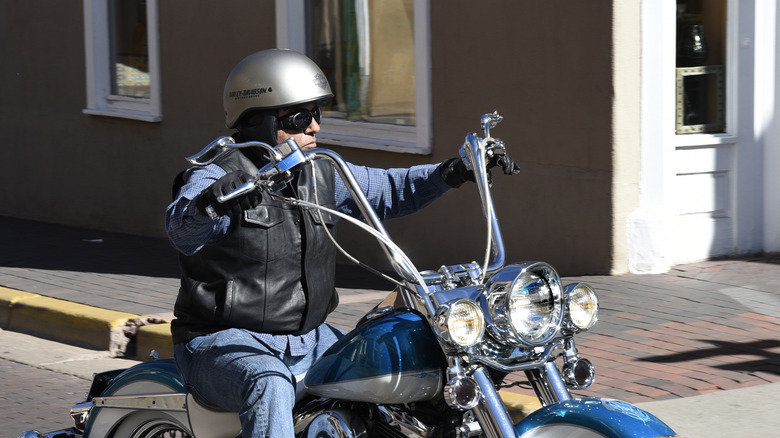 man riding with ape handlebars