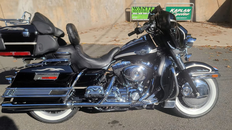 A black 2003 100th anniversary Harley Ultra Glide classic on display at the side of a road