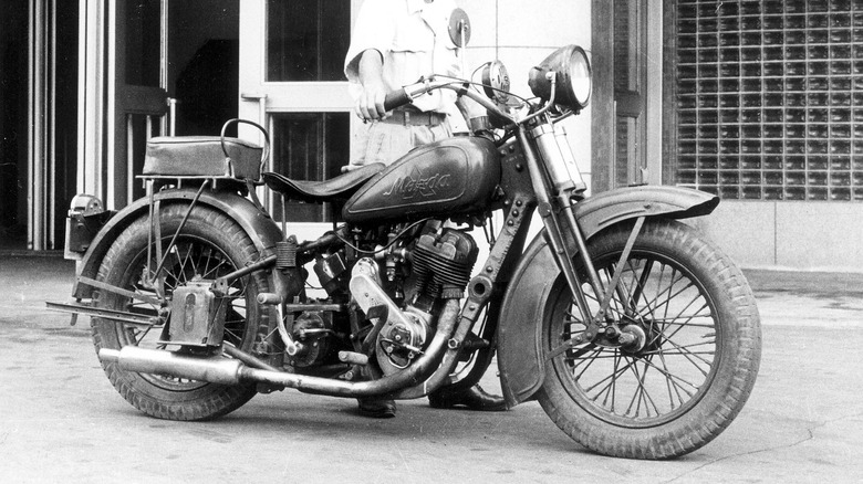 Man with early Mazda motorcycle