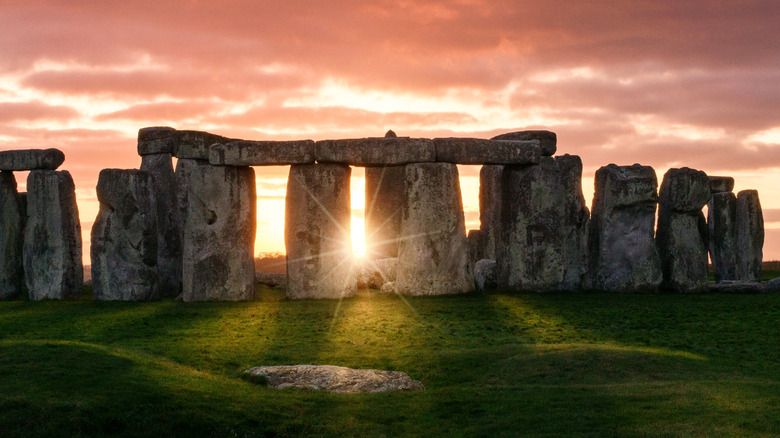 Sun peeking through Stonehenge. 