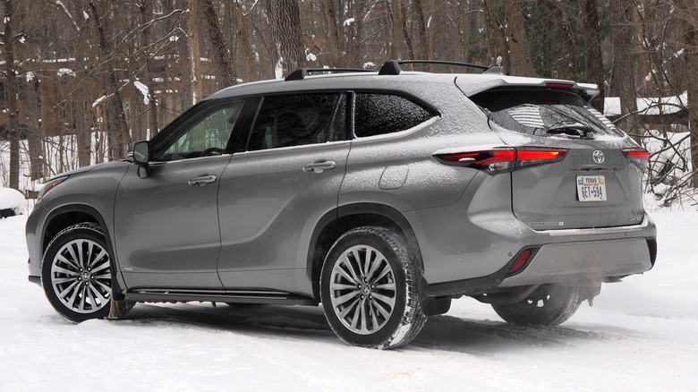 2026 Toyota Highlander Hybrid rear 3/4 view in snow