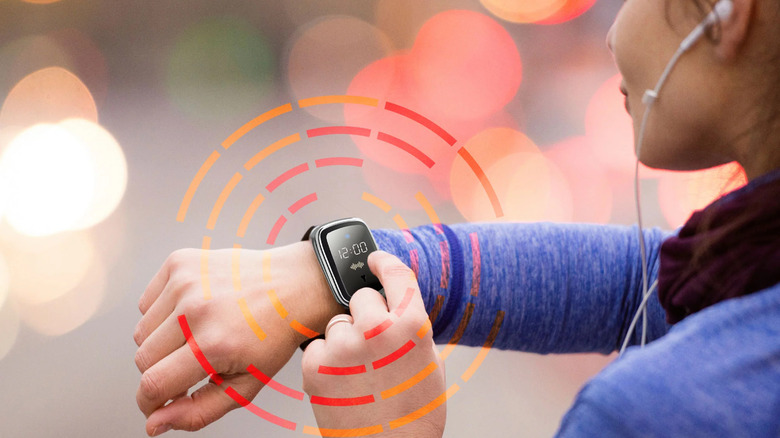 woman pressing bug repellant watch
