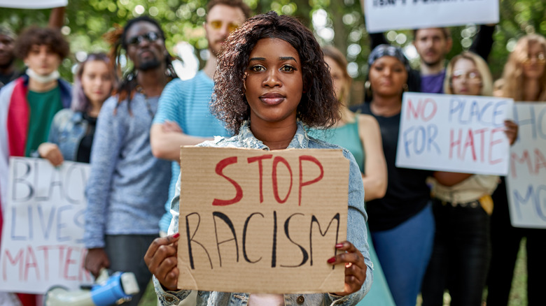 Woman holds sign