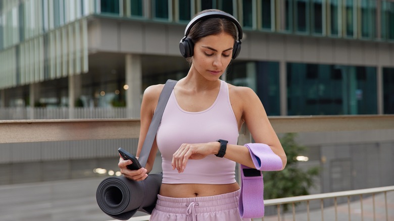 woman checking fitness device on her wrist