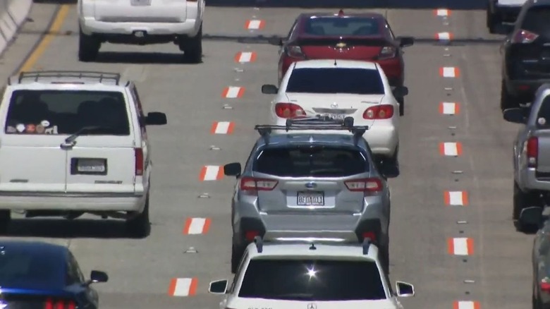 Image of orange caution lines painted on a freeway in San Diego, California.