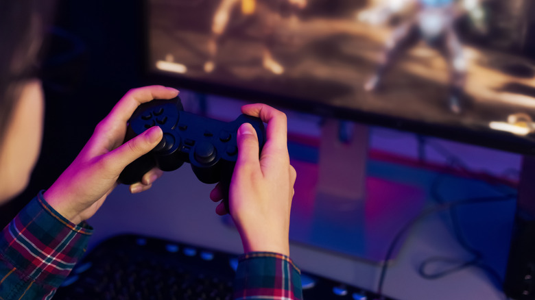 A person gaming on a computer.