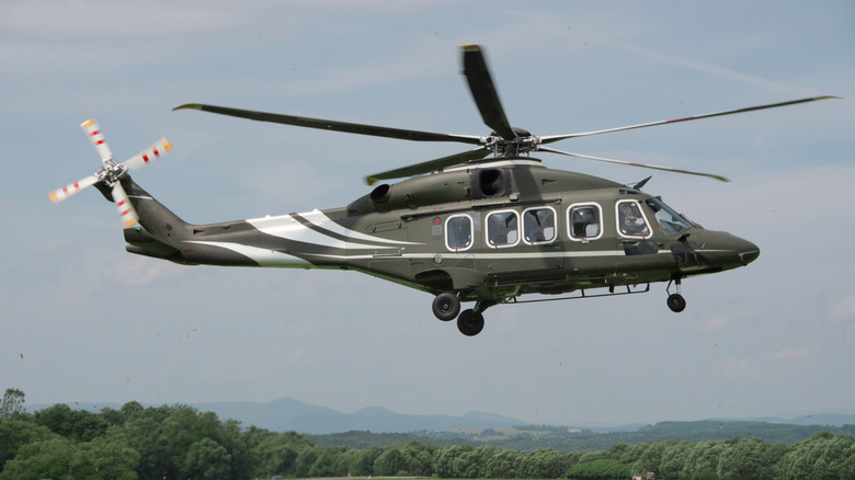 A helicopter prepares to land on the ground