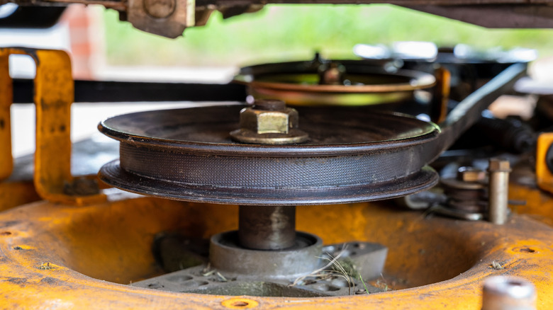 Picture showing a lawn mower spindle with belt attached