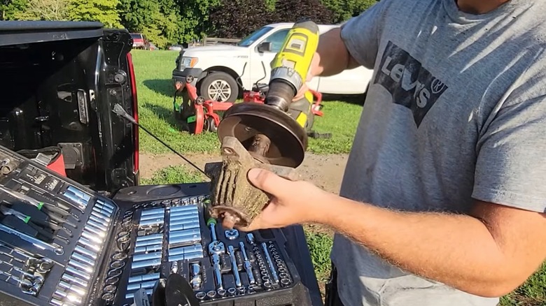 Person testing their lawn mower spindle with a power drill