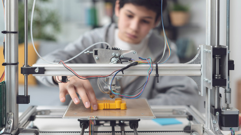 Boy using 3D printer