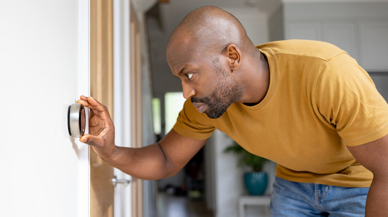Person changing thermostat