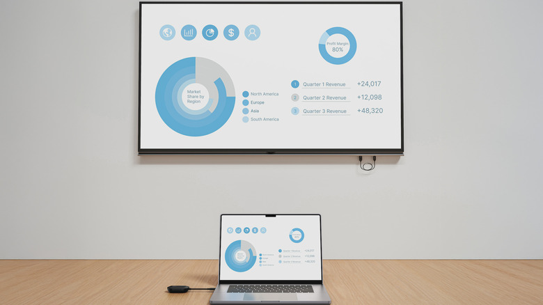 ConnectAir wireless HDMI display adapter in use on laptop in conference room