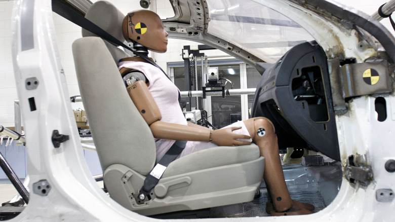 Crash dummy sits in car before it is safety-tested