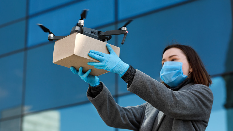 Medical personnel receiving medical aid via drone