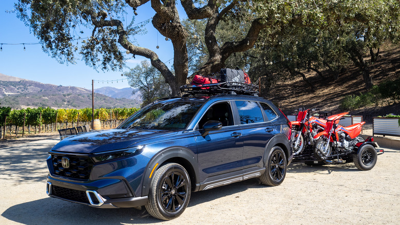 2023 Honda CR-V Hybrid parked with motorcycle trailer