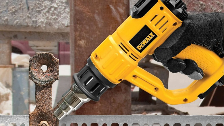 A person using DeWalt's cordless heat gun.