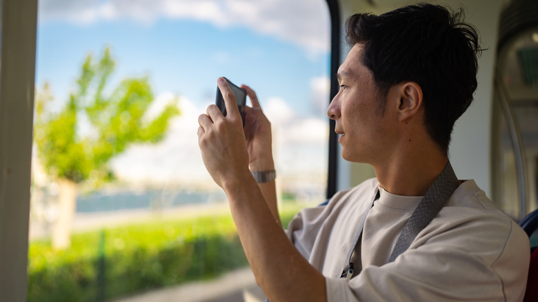 male tourist taking a photo