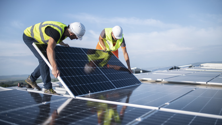 workers installing solar panels