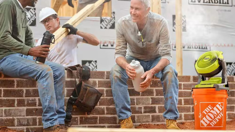 Construction workers using Ryobi bucket top misting fan on construction site