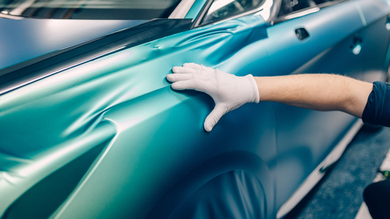 hand pressing car wrap