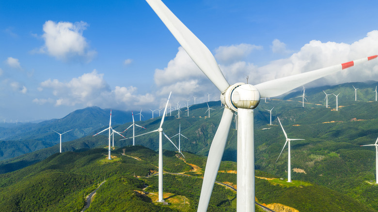 An aerial view of a large wind farm on hilly land