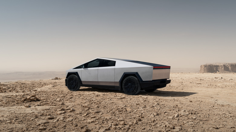 Rear 3/4 view of the Tesla Cybertruck in a desert