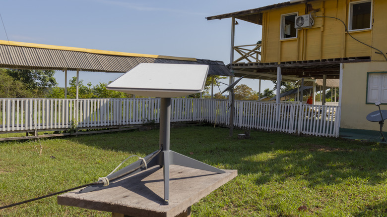Starlink receiver kit in a backyard