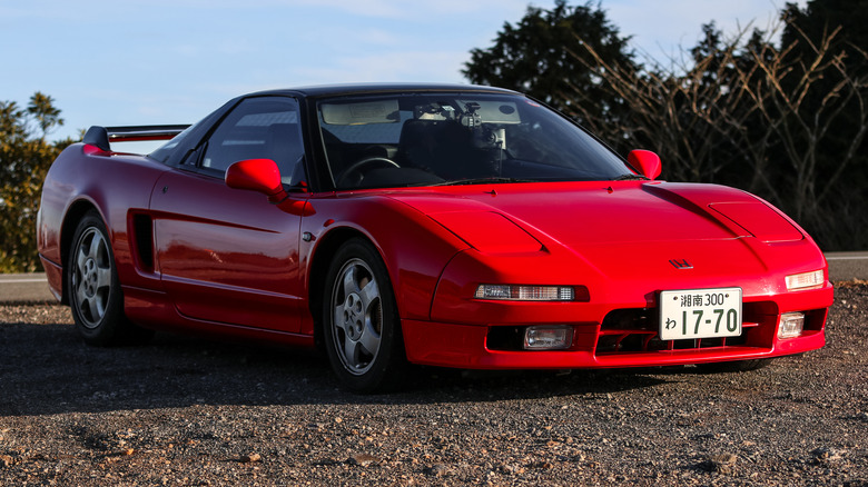 Red first-generation Acura NSX parked