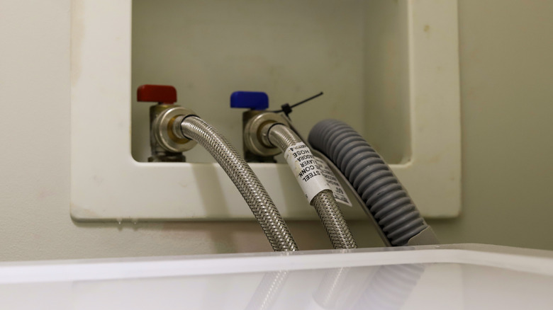 Close-up of a washing machine's three hoses