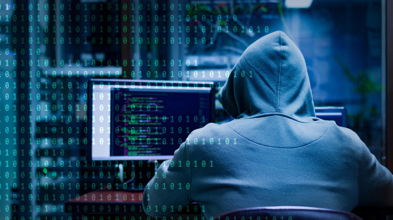 hacker with his back turned to the camera
