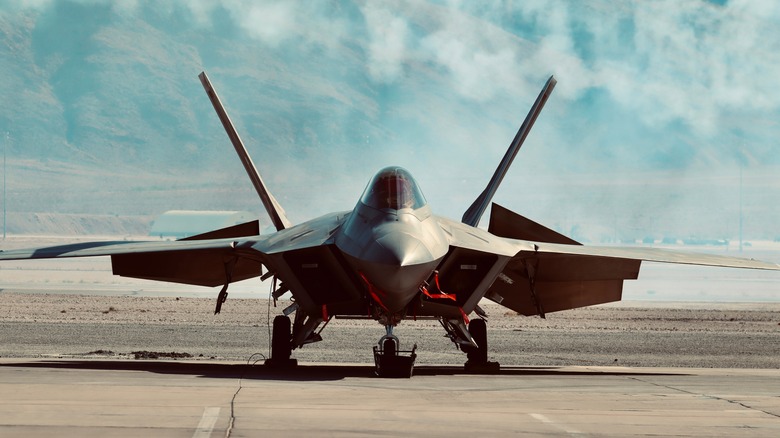 A jet fighter on a runway on a sunny day