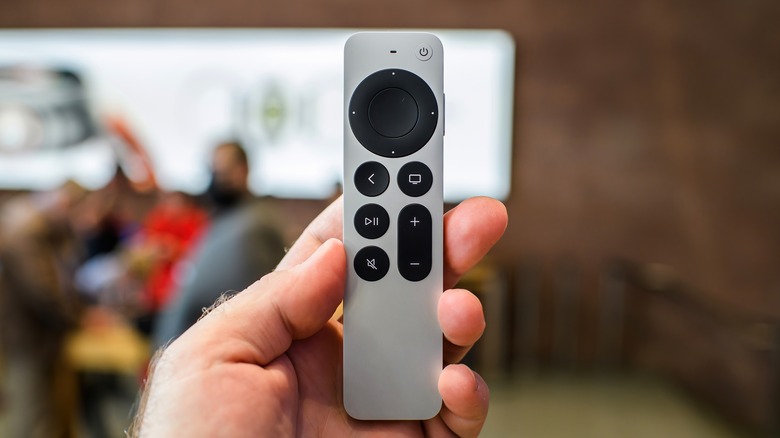 Holding Apple TV watch 