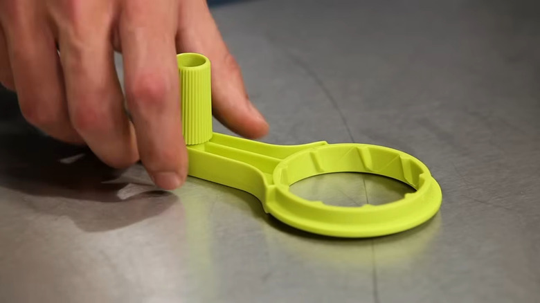Hand reaching for Ryobi crank attachment