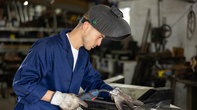 Welder with welding helmet up