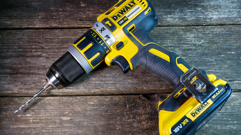 A DeWalt drill on a wood table.