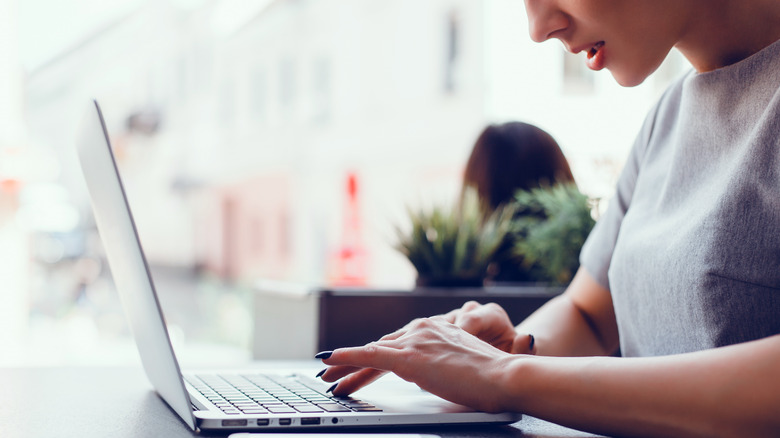 woman using MacBook indoors