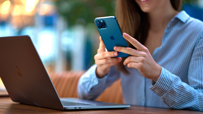 woman taking photos of macbook