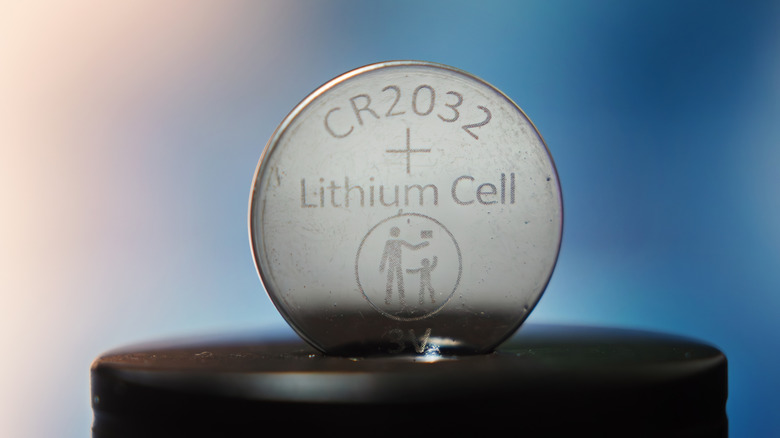 An extreme close-up of a 3V CR2032 button cell battery