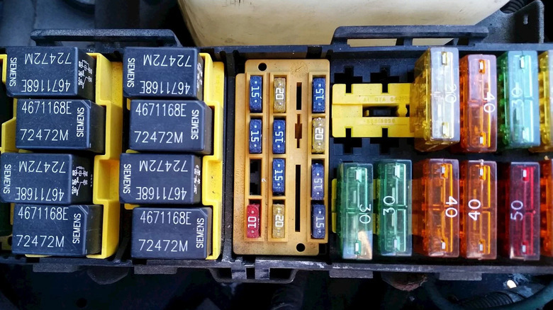 many automotive fuses in a fuse panel