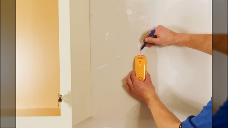 A man using a Zircon stud finder
