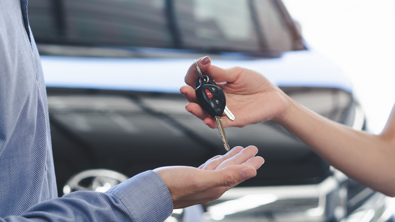 Car owner handing keys to customer