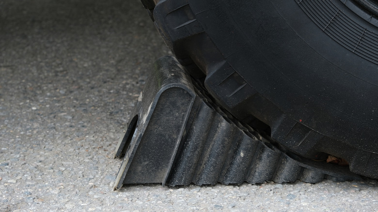 Close-up of a tyre on a wheel chock.