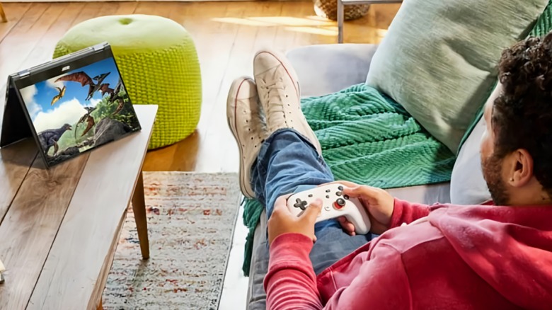 Person gaming with Bluetooth controller on Chromebook