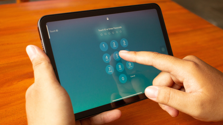 Person entering passcode on an iPad