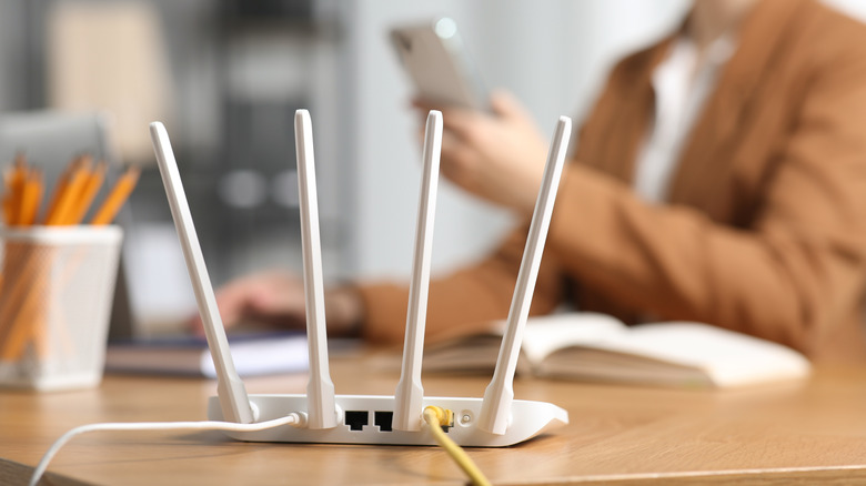 Wi-Fi router on a table with person in background