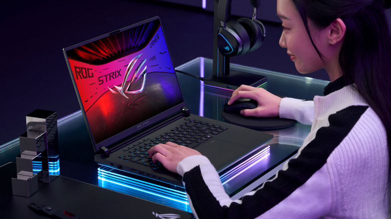 Woman playing games on ASUS ROG Strix Scar 16 18 gaming laptop