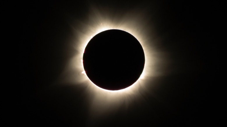 solar eclipse over mountain range