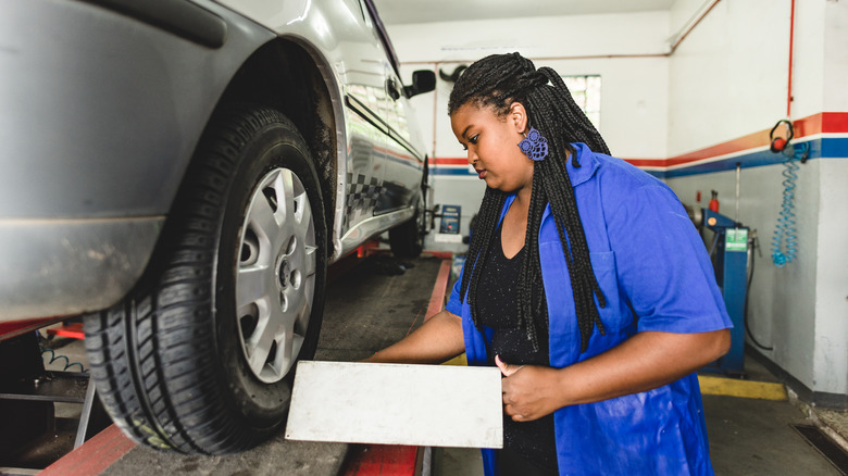 Mechanic checking wheel alignment